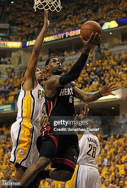 LeBron James of the Miami Heat puts up a shot past Danny Granger and Leandro Barbosa of the Indiana Pacers in Game Six of the Eastern Conference...