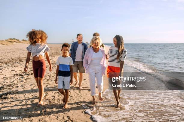 always together - multi generation family beach stock pictures, royalty-free photos & images