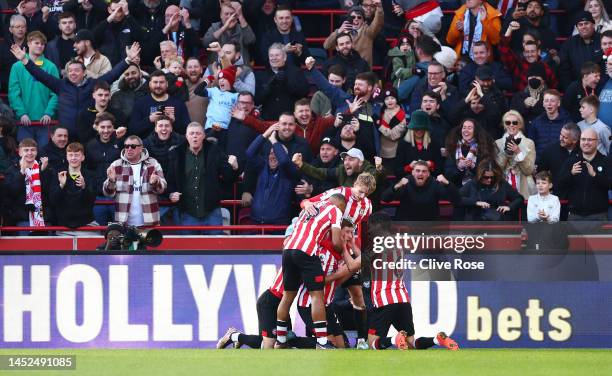 Vitaly Janelt of Brentford celebrates with team mates after scoring their side's first goal during the Premier League match between Brentford FC and...