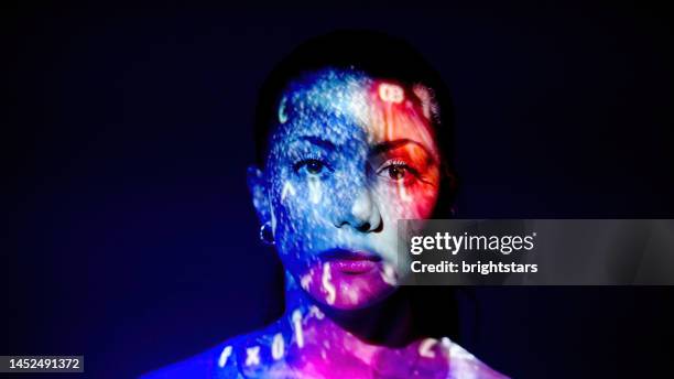 multicolored lights on a woman's face - face projection stock pictures, royalty-free photos & images