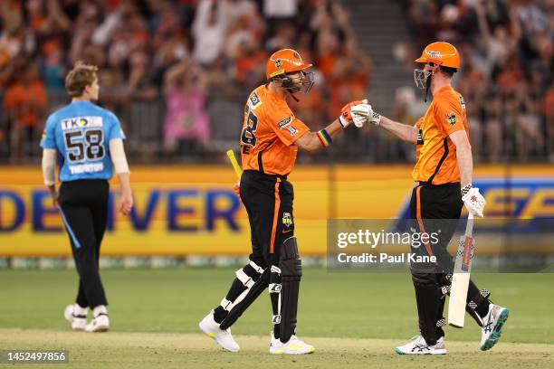 Andrew Tye and Ashton Turner of the Scorchers celebrate a boundary during the Men's Big Bash League match between the Perth Scorchers and the...