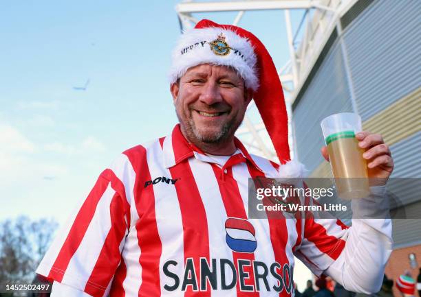 Southampton fan wearing a Christmas hat poses for a photograph prior to the Premier League match between Southampton FC and Brighton & Hove Albion at...