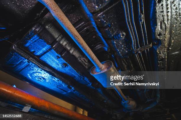 vehicle underbody exhaust pipe, catalyst, resonator, exhaust system. car service and maintenance. standards and technical condition. anti-corrosion coating of the bottom of the car. selective focus - dpf stock pictures, royalty-free photos & images