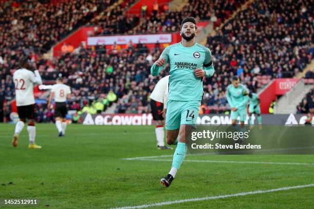 Adam Lallana of Brighton & Hove Albion celebrates after scoring their sides first goal during the Premier League match between Southampton FC and...