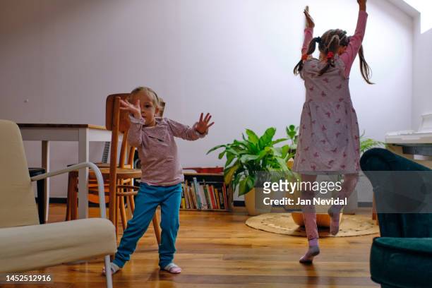 two small girls dancing in the living room - sister act stock pictures, royalty-free photos & images