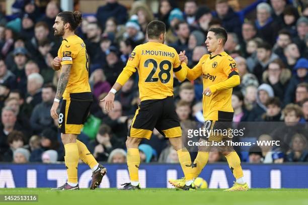 Daniel Podence of Wolverhampton Wanderers celebrates after scoring their side's first goal with Joao Moutinho during the Premier League match between...
