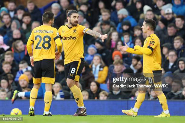 Daniel Podence of Wolverhampton Wanderers celebrates with Joao Moutinho and Ruben Neves after scoring their side's first goal during the Premier...