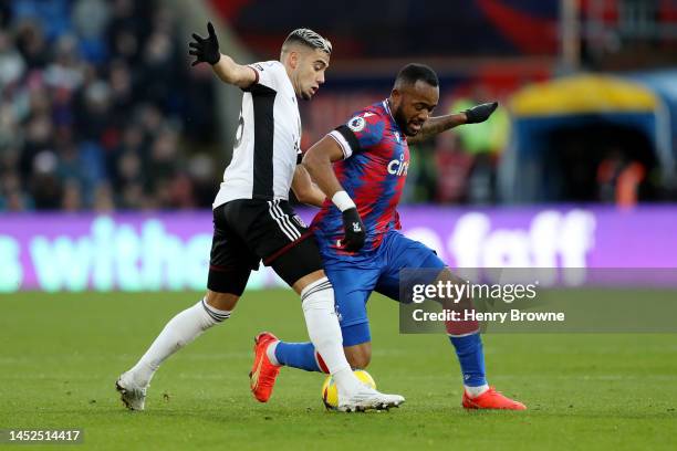 Andreas Pereira of Fulham battles for possession with Jordan Ayew of Crystal Palace during the Premier League match between Crystal Palace and Fulham...