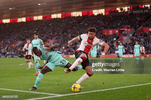 Che Adams of Southampton is challenged by Moises Caicedo of Brighton & Hove Albion during the Premier League match between Southampton FC and...