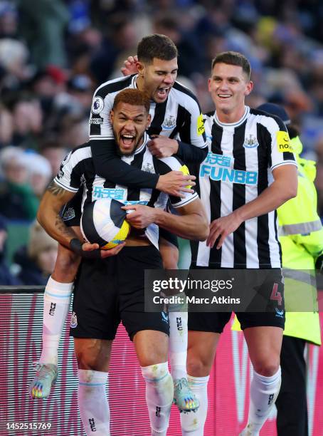 Joelinton of Newcastle United celebrates with teammates after scoring the team's third goal during the Premier League match between Leicester City...