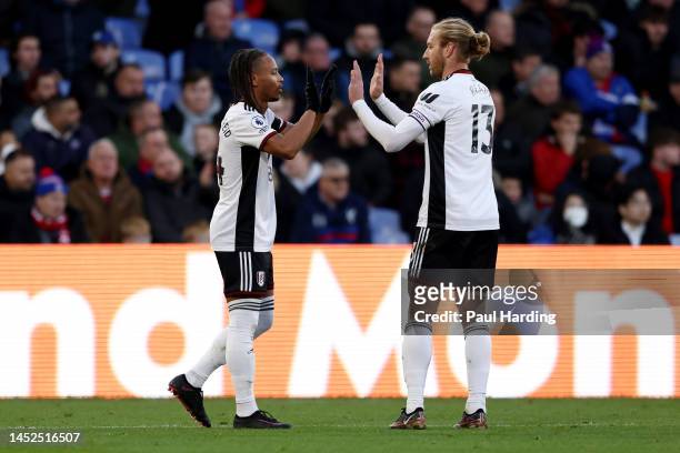 Bobby Reid of Fulham celebrates with team mate Tim Ream after scoring their sides first goal during the Premier League match between Crystal Palace...