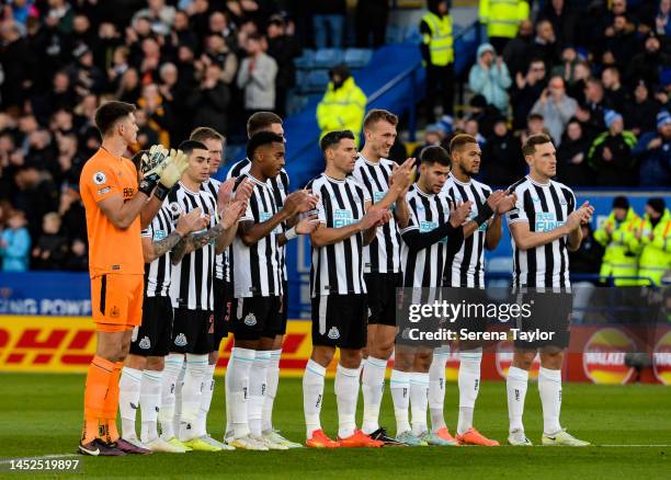Newcastle players line up for a minutes applause during the Premier League match between Leicester City and Newcastle United at The King Power...
