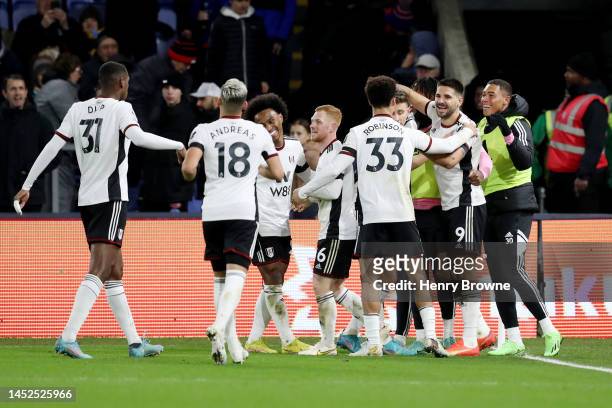 Aleksandar Mitrovic of Fulham celebrates with team mates after scoring their sides third goal during the Premier League match between Crystal Palace...