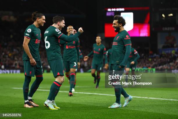 Mohamed Salah of Liverpool celebrates with teammate Andy Robertson after scoring their side's first goal during the Premier League match between...