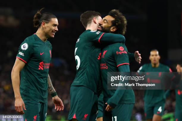 Mohamed Salah of Liverpool celebrates with teammates Darwin Nunez and Andy Robertson after scoring their side's first goal during the Premier League...
