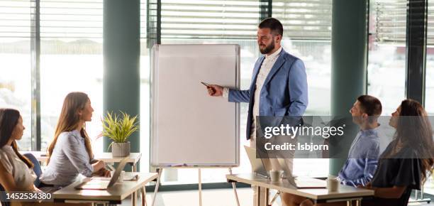 businessman giving his team a presentation in the office - norway womens training session stock pictures, royalty-free photos & images