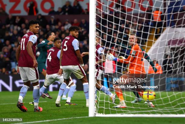 Ollie Watkins, Tyrone Mings and Robin Olsen of Aston Villa watch the ball hit the back of the net as Virgil van Dijk of Liverpool scores their side's...