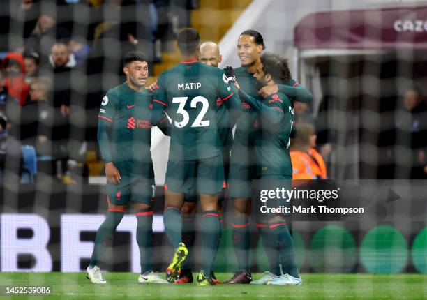 Virgil van Dijk of Liverpool celebrates with teammates Joel Matip, Alex Oxlade-Chamberlain, Fabinho and Mohamed Salah after scoring their side's...