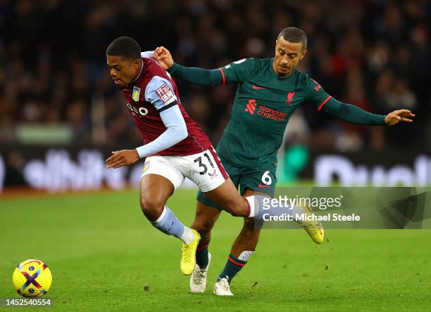 Leon Bailey of Aston Villa is challenged by Thiago Alcantara of Liverpool during the Premier League match between Aston Villa and Liverpool FC at...