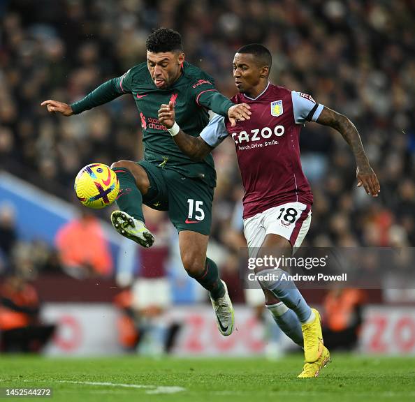 Alex Oxlade-Chamberlain of Liverpool with Ashley Young of Aston Villa