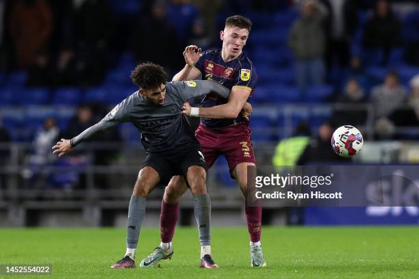 Kion Etete of Cardiff City is challenged by Jimmy Dunne of Queens Park Rangers during the Sky Bet Championship between Cardiff City and Queens Park...