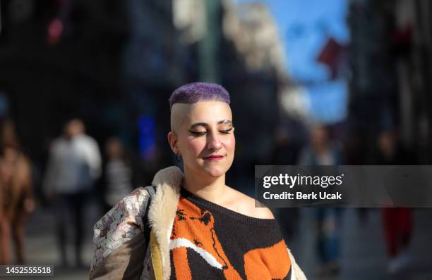 a tourist with purple hair is walking on istiklal avenue. - purple hair stock pictures, royalty-free photos & images