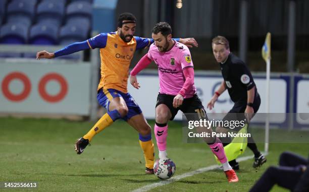 Danny Hylton of Northampton Town controls the ball watched by James Perch of Mansfield Town during the Sky Bet League Two between Mansfield Town and...