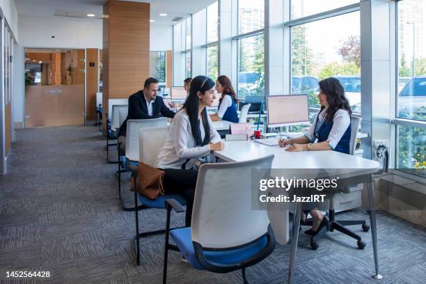 employees helping customers - credit union stock pictures, royalty-free photos & images