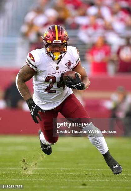 Antonio Gibson of the Washington Commanders carries the ball against the San Francisco 49ers during the fourth quarter of an NFL football game at...