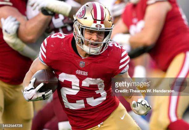 Christian McCaffrey of the San Francisco 49ers carries the ball against the Washington Commanders during the fourth quarter of an NFL football game...