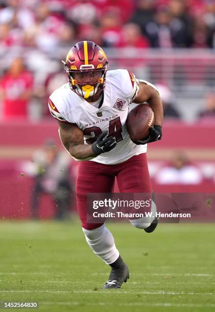 Antonio Gibson of the Washington Commanders carries the ball against the San Francisco 49ers during the fourth quarter of an NFL football game at...