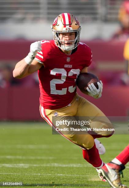 Christian McCaffrey of the San Francisco 49ers carries the ball against the Washington Commanders during the first quarter of an NFL football game at...