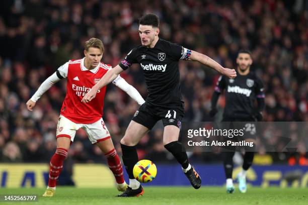Declan Rice of West Ham United is challenged by Martin Oedegaard of Arsenal during the Premier League match between Arsenal FC and West Ham United at...
