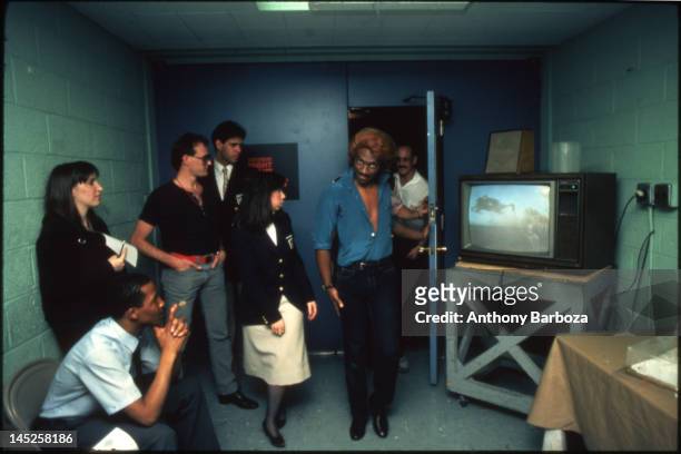 American musician comedian and actor Eddie Murphy , in costume as the character Dion, backstage during an episode of 'Saturday Night Live,' New York,...