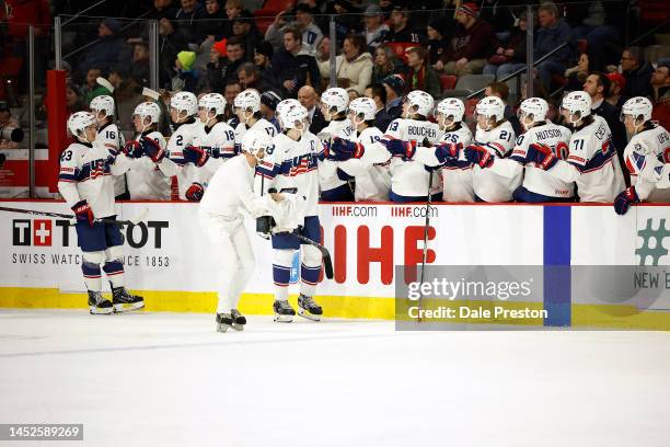 Luke Hughes of Team USA celebrates with his team during the game against Team Latvia during the third period at Avenir Centre on December 26, 2022 in...