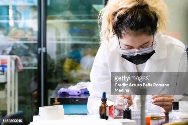 female chemist in action - microbiology stock pictures, royalty-free photos & images