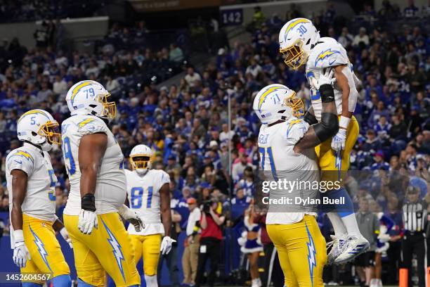 Austin Ekeler of the Los Angeles Chargers celebrates after a touchdown against the Indianapolis Colts at Lucas Oil Stadium on December 26, 2022 in...