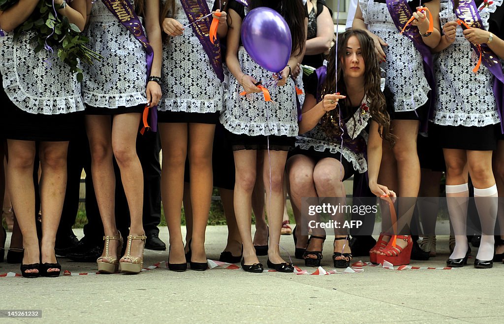 High-school graduates celebrate the last