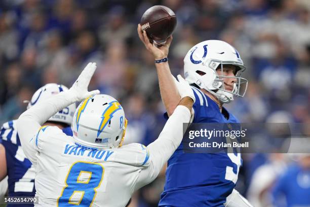 Nick Foles of the Indianapolis Colts attempts a throw over Kyle Van Noy of the Los Angeles Chargers at Lucas Oil Stadium on December 26, 2022 in...