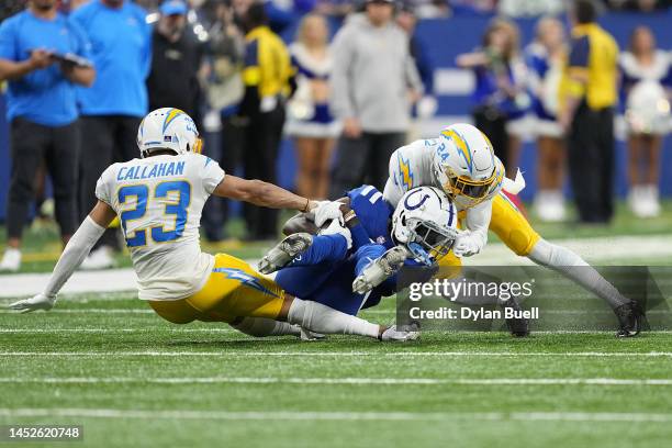 Parris Campbell of the Indianapolis Colts is tackled by Bryce Callahan of the Los Angeles Chargers and Nasir Adderley of the Los Angeles Chargers at...