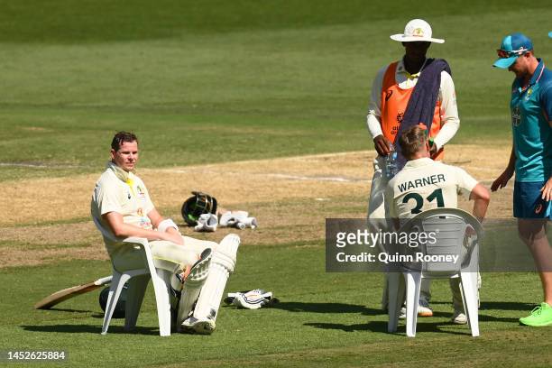 Steve Smith and David Warner of Australia rest during a drinks break during day two of the Second Test match in the series between Australia and...