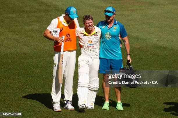 David Warner of Australia leaves the field injured after celebrating his double century during day two of the Second Test match in the series between...