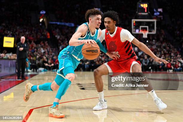 LaMelo Ball of the Charlotte Hornets drives against Keon Johnson of the Portland Trail Blazers during the third quarter at the Moda Center on...