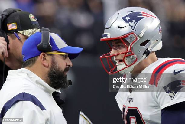 Senior football advisor and offensive line coach Matt Patricia of the New England Patriots talks with quarterback Mac Jones during a timeout in the...