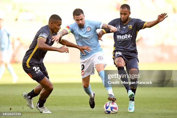 Daniel Hall and Marco Tulio of the Mariners attempt to defend against Jamie Maclaren of Melbourne City during the round nine A-League Men's match...