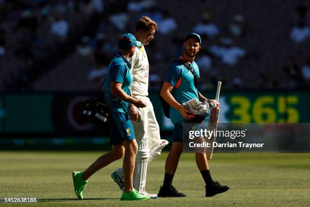 Cameron Green of Australia retires hurt during day two of the Second Test match in the series between Australia and South Africa at Melbourne Cricket...