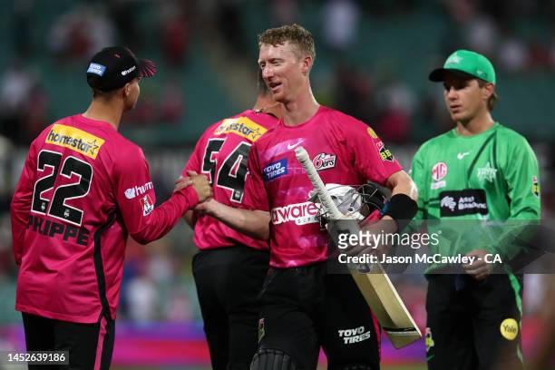 Jordan Silk of the Sixers celebrates victory with Josh Philippe during the Men's Big Bash League match between the Sydney Sixers and the Melbourne...