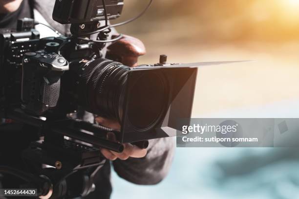 filmmaker use cinema camera shooting footage - film reel stock-fotos und bilder