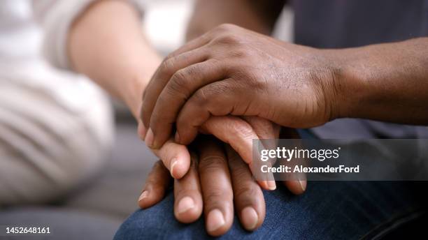 support, help and couple holding hands for hope, empathy and love in marriage therapy. security, trust and man and woman with solidarity, kindness and gratitude in counseling with care and respect - holding hands 個照片及圖片檔