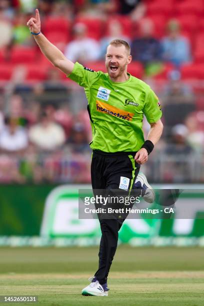 Nathan McAndrew of the Thunder celebrates after taking the wicket of Sam Billings of the Heat during the Men's Big Bash League match between the...
